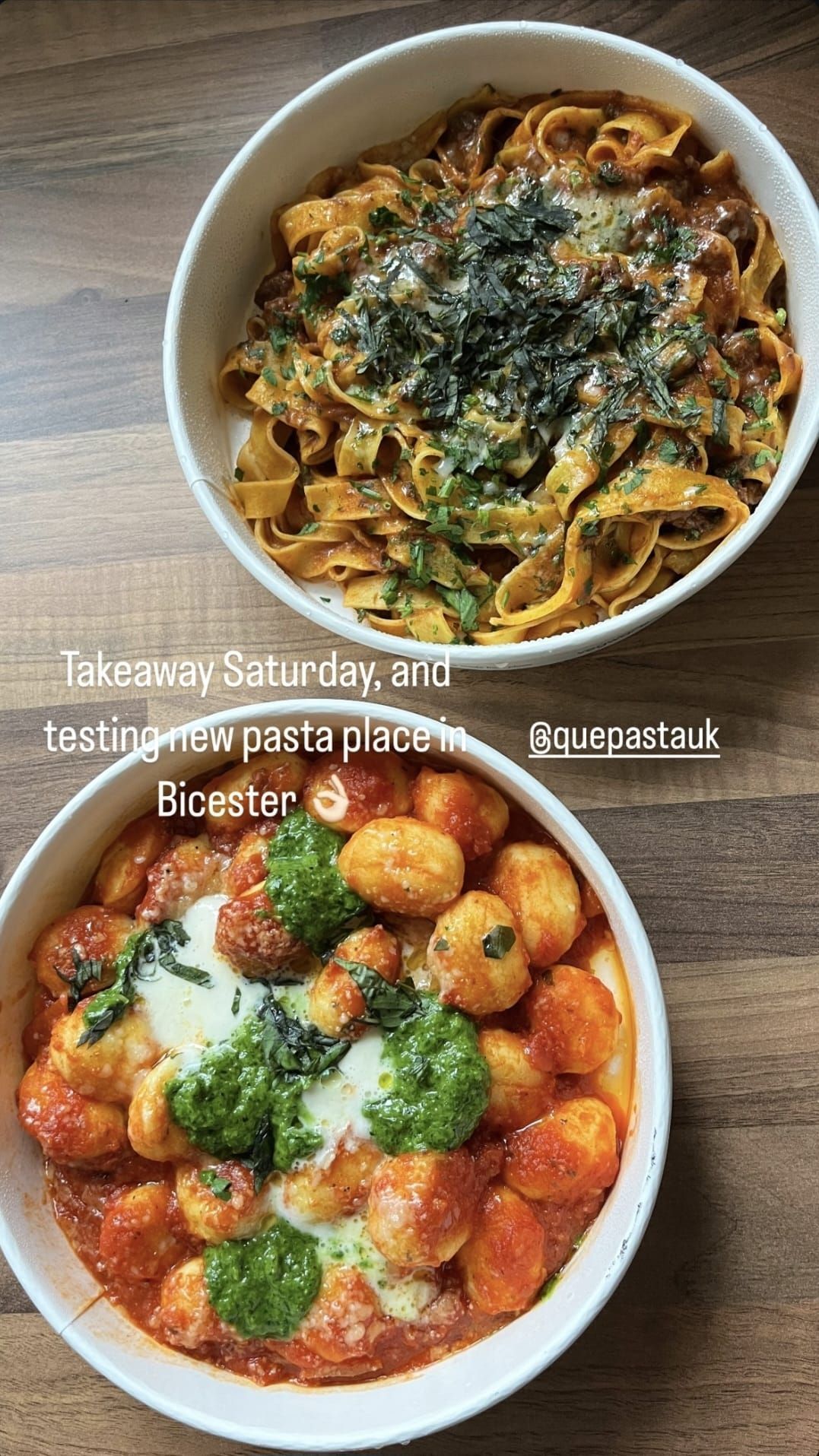 Two bowls of food are sitting on a wooden table.