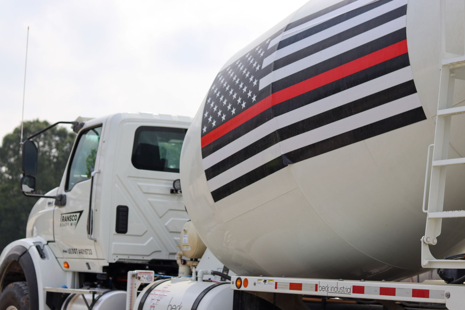 Concrete Mixer Truck with US Flag and Red Stripe