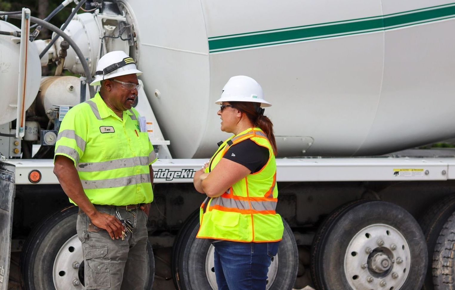 Woman and Man Concrete Workers having a discussion