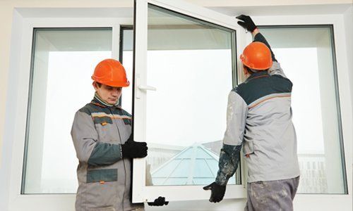 Two technicians repairing the window