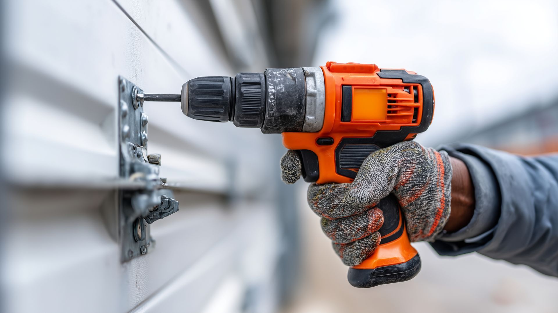 Technician replacing garage door panels after damage.