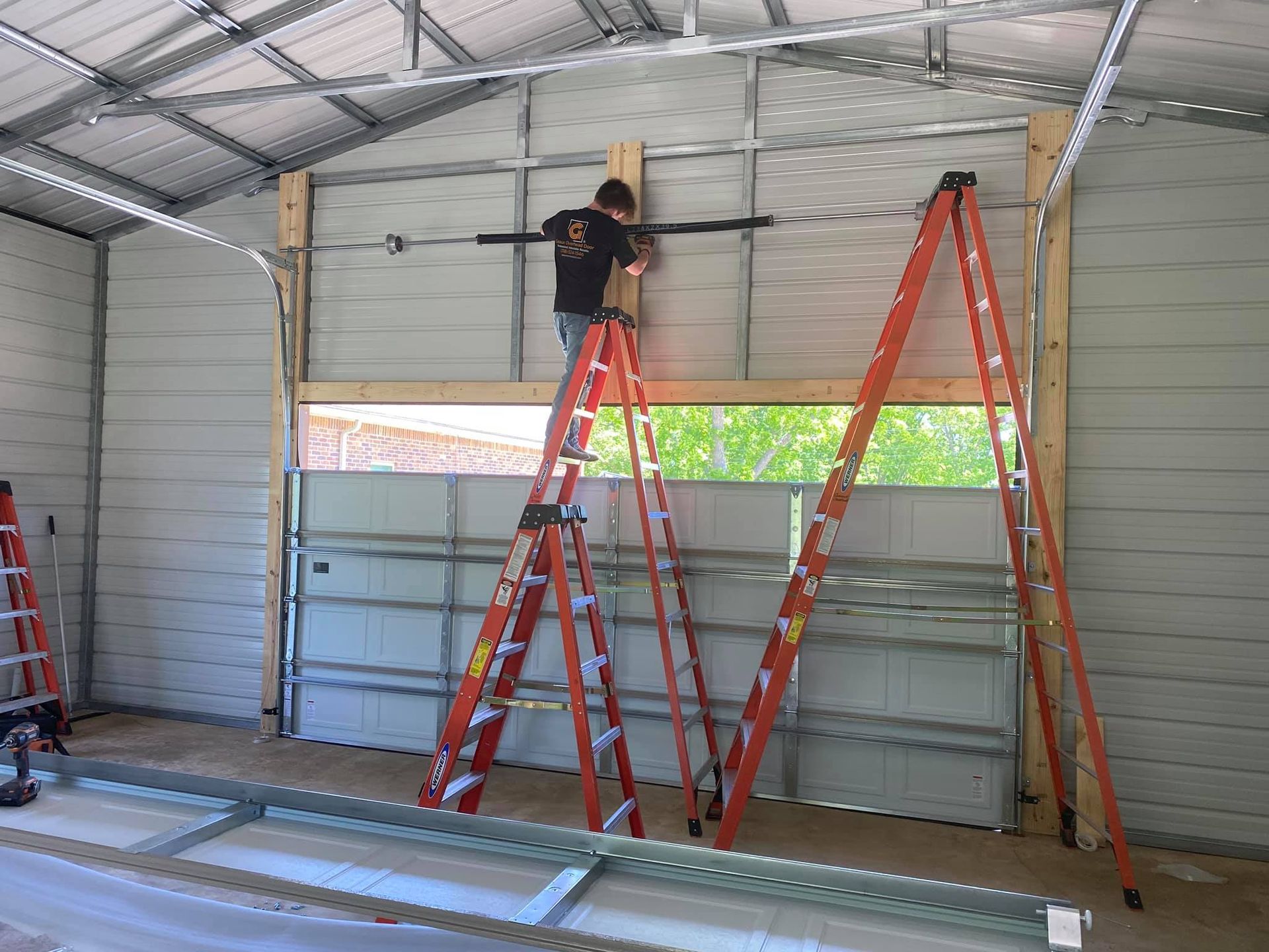 Worker Repairing a Garage Door Opener