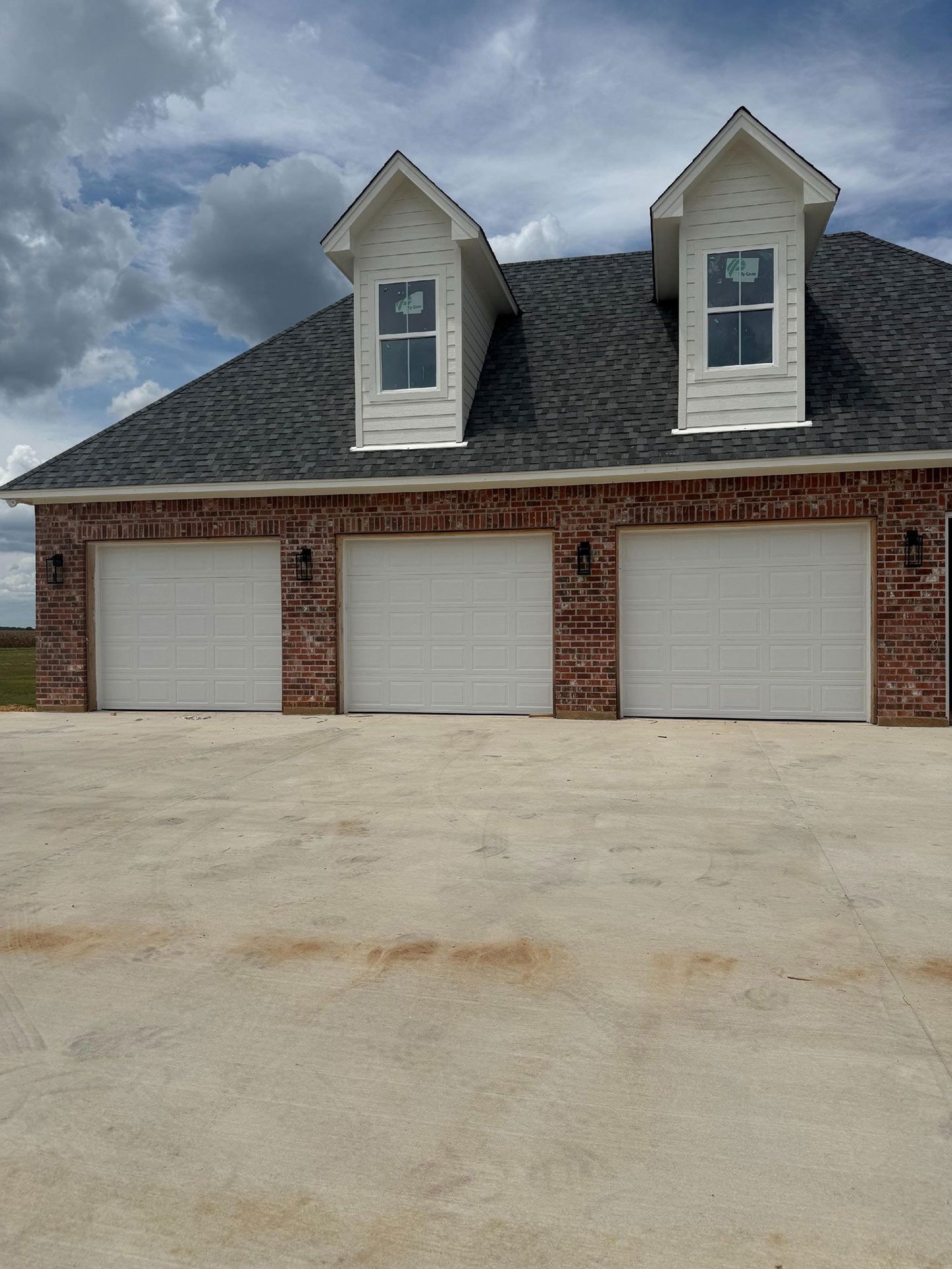 Three Garage Doors with Brick Facade