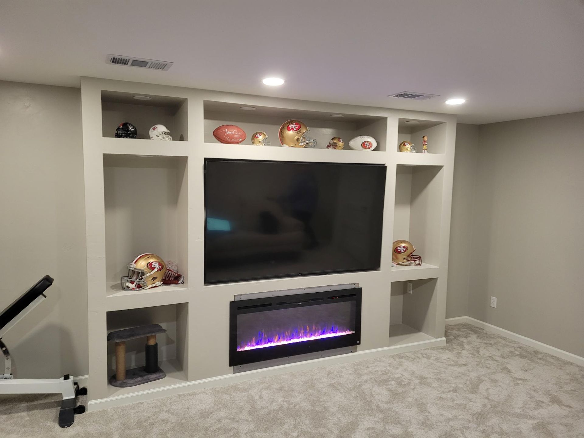 A living room with a fireplace and a flat screen tv.