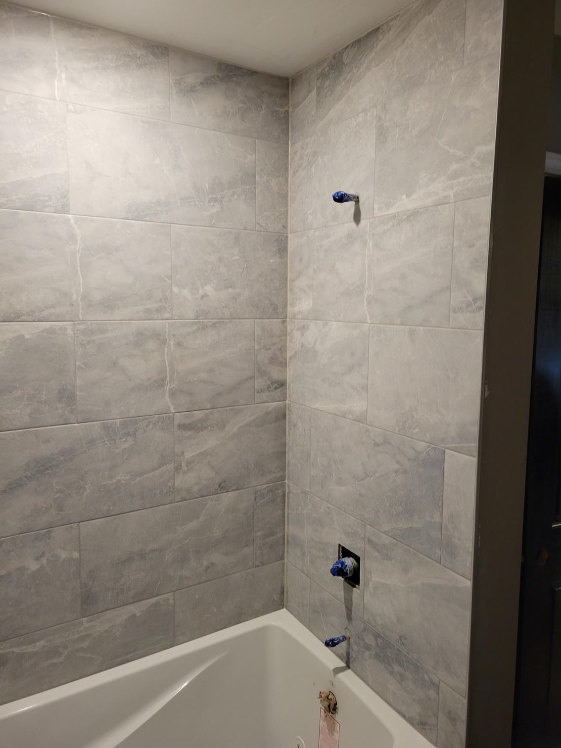 A bathroom with a bathtub and a shower.