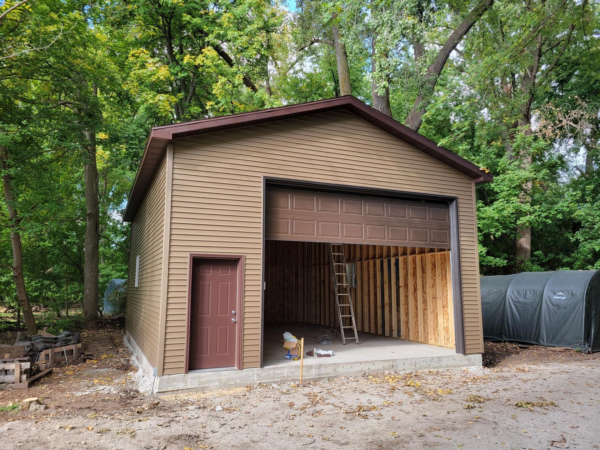 A garage is being built in the middle of a forest.