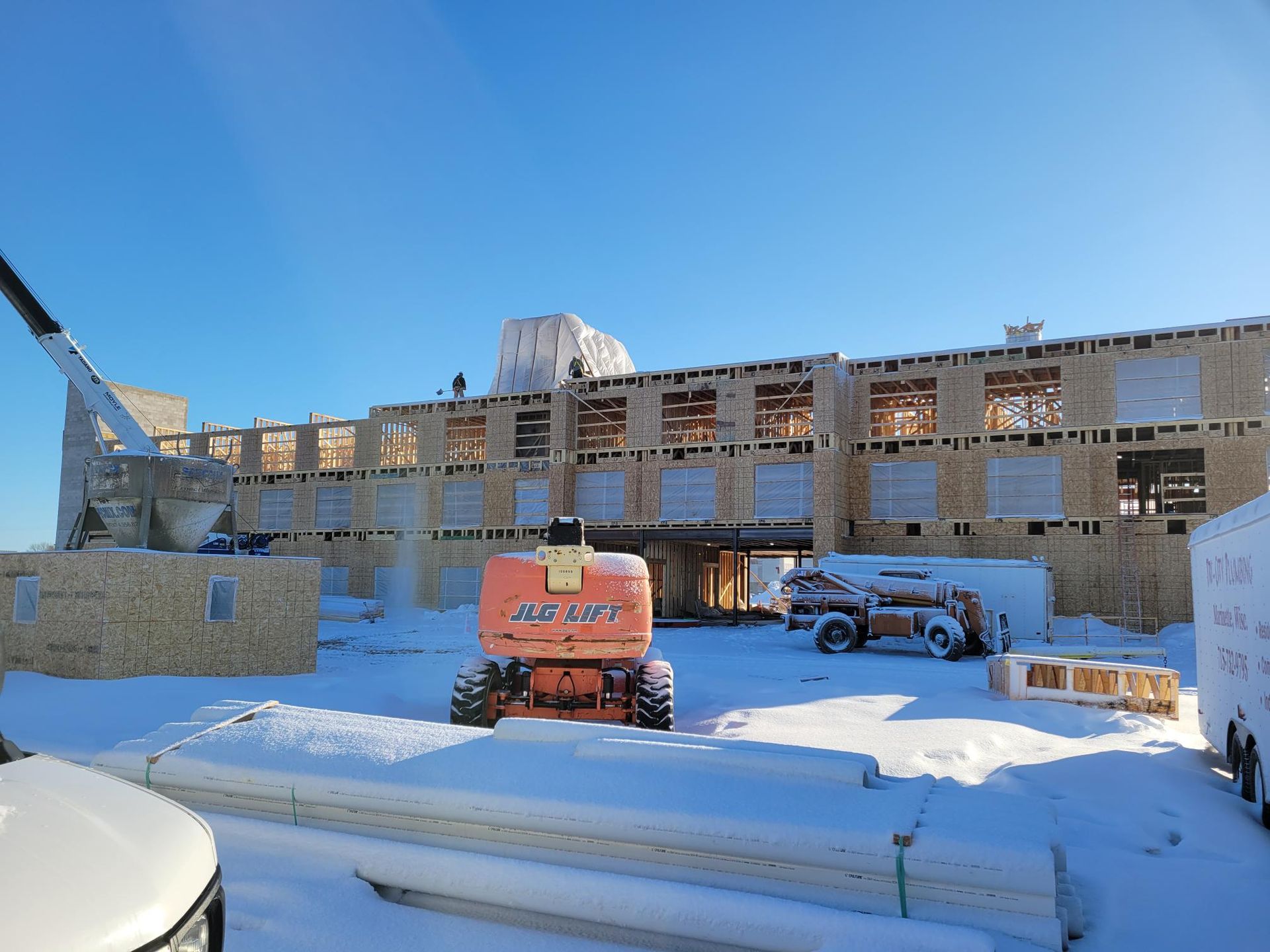 A large building is being built in the snow.