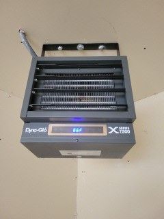 A heater is hanging from the ceiling in a room.