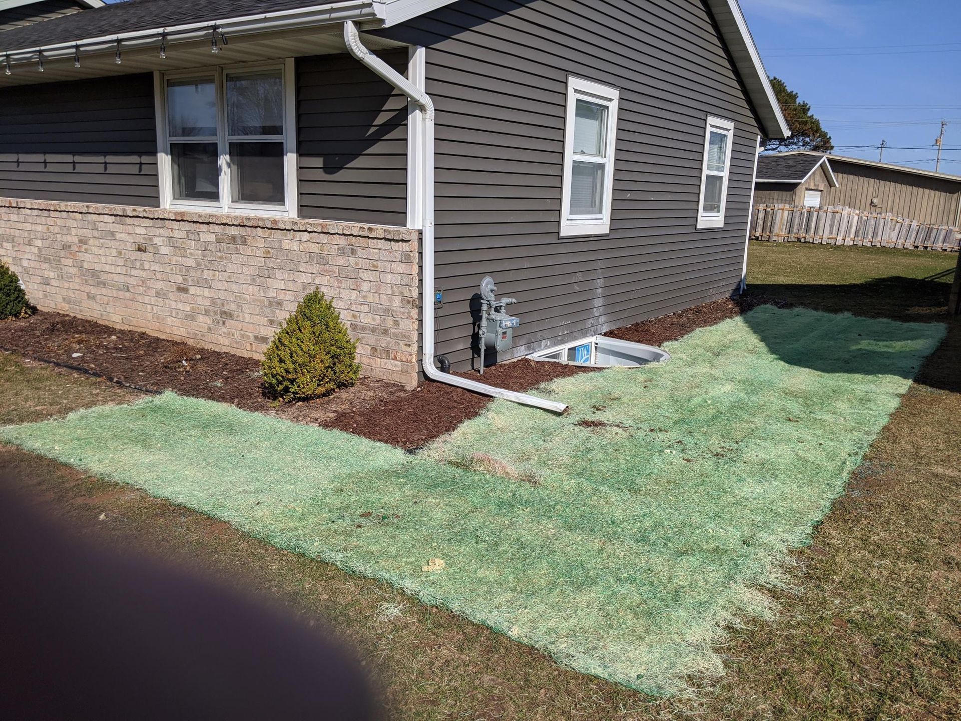 A house with a green lawn in front of it.