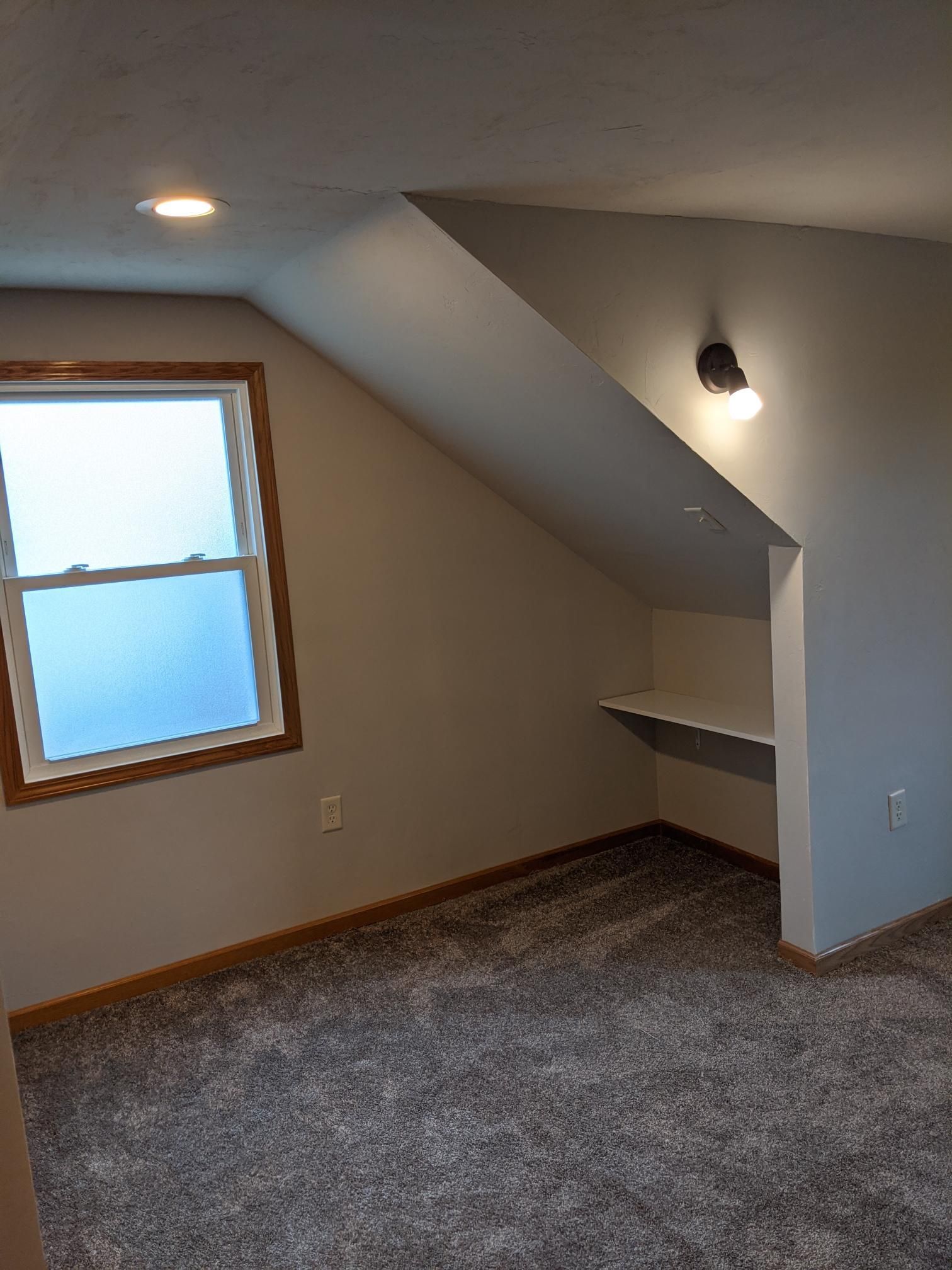 There is a window in the corner of the room.