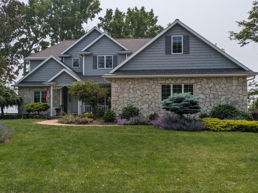 A large house with a lush green lawn in front of it