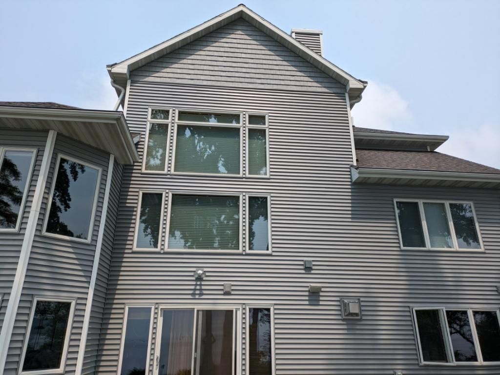 The back of a large house with a lot of windows