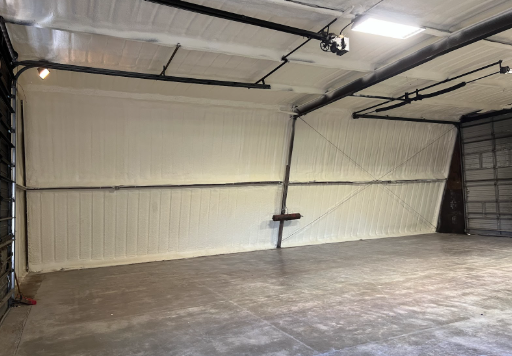 Interior of a large garage insulated with white foam.