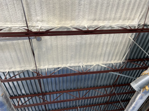 Spray foam insulation on metal building ceiling in Dacono, Colorado