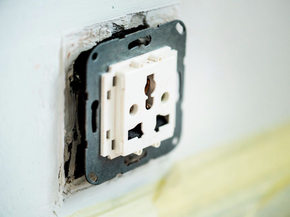 A close up of an electrical outlet on a wall.