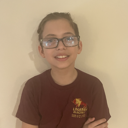 A young boy wearing glasses and a linare 's electric shirt