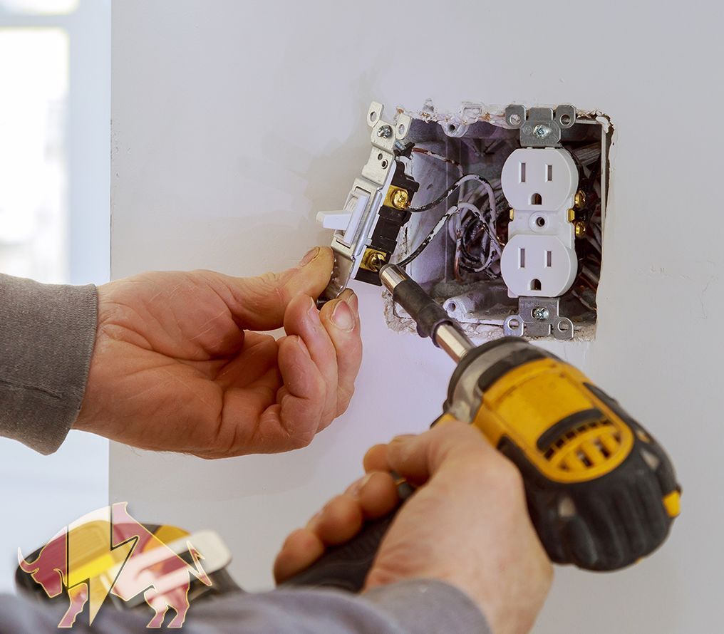 A man is using a dewalt drill to install an electrical outlet