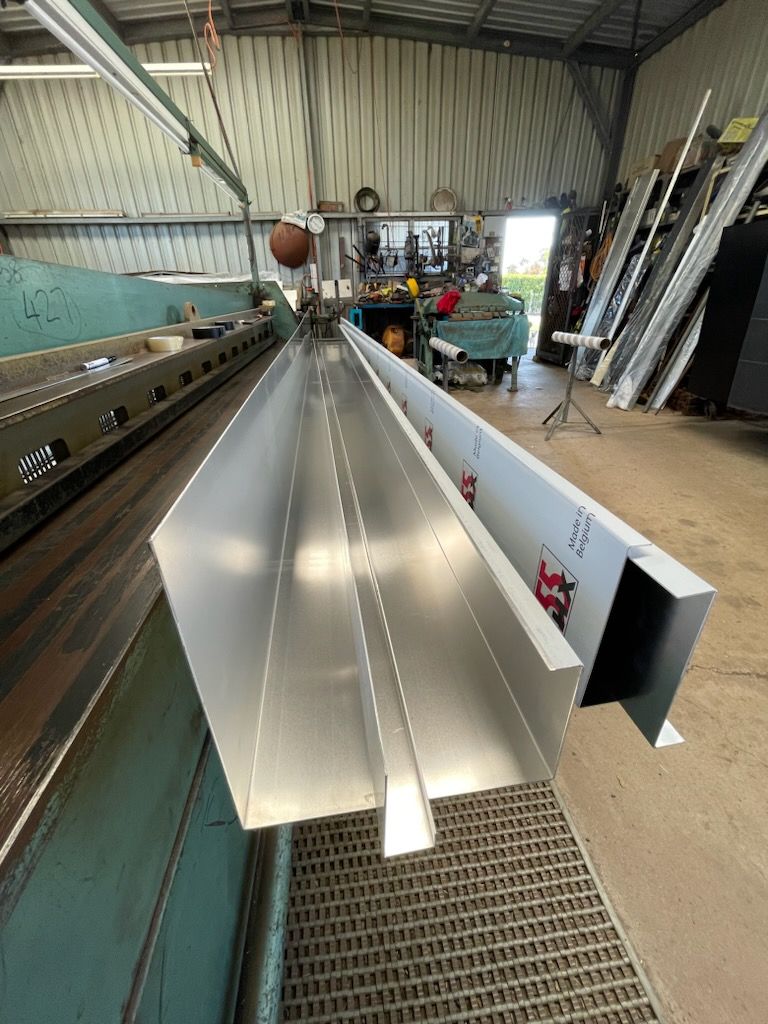 A large piece of metal is sitting on top of a machine in a factory  | Berkshire Park, NSW | V.J.S. Aluminium & Steel
