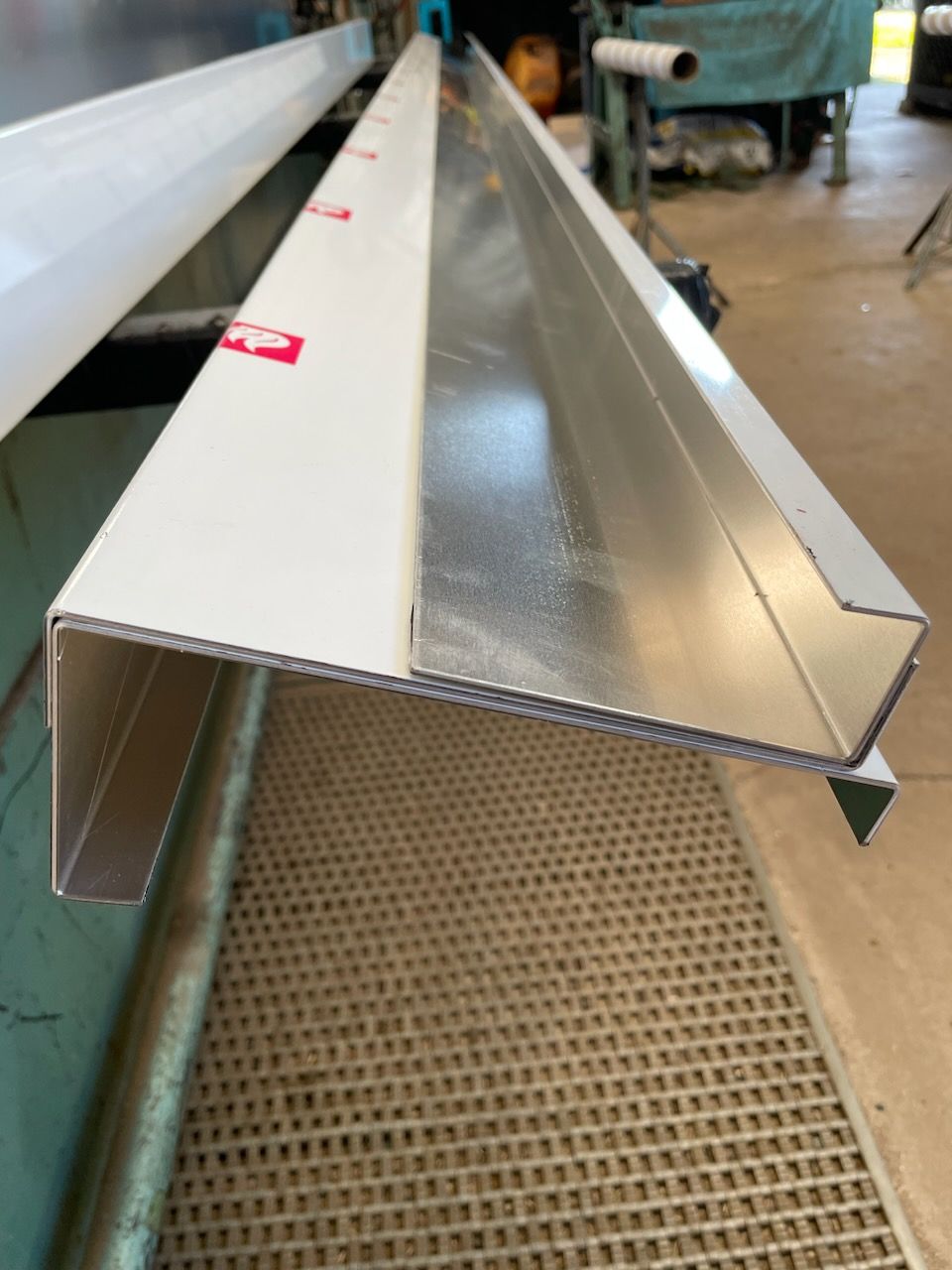 A piece of metal with a red sticker that says ' aluminum ' on it  | Berkshire Park, NSW | V.J.S. Aluminium & Steel