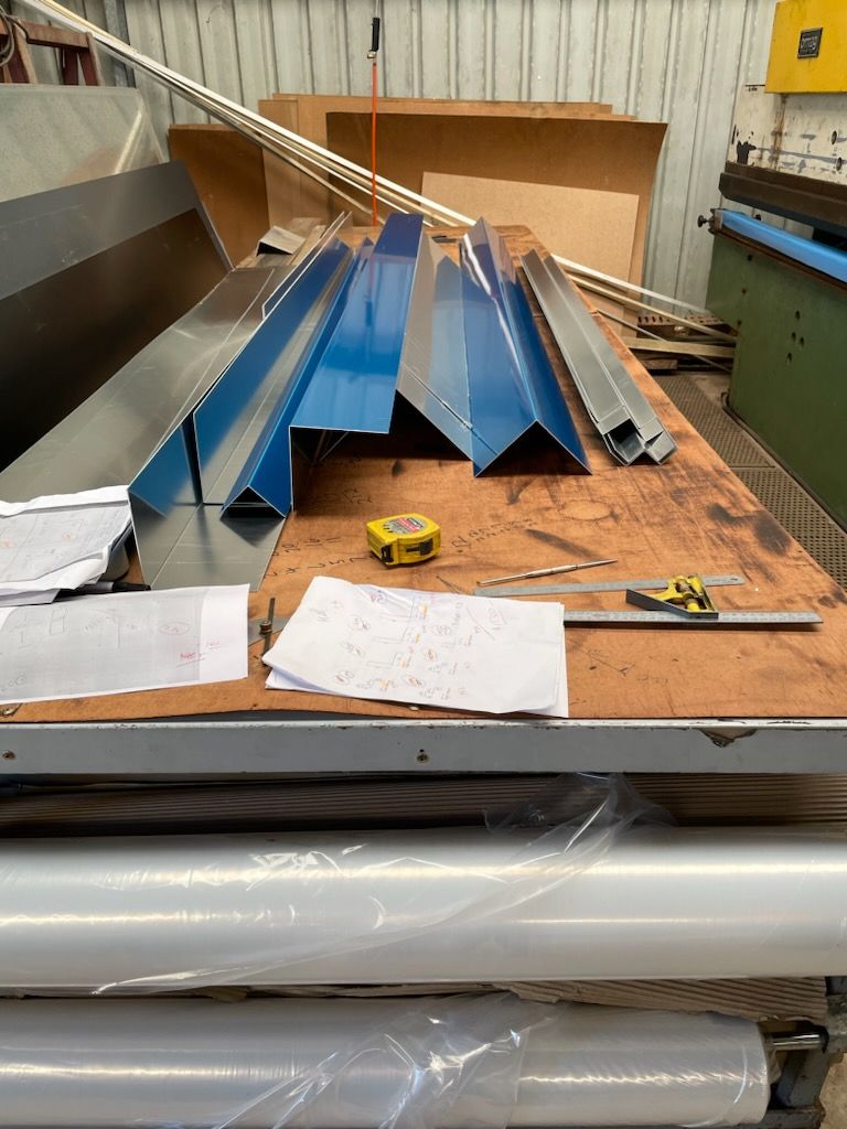 A table with a bunch of metal pieces on it and a tape measure on it  | Berkshire Park, NSW | V.J.S. Aluminium & Steel