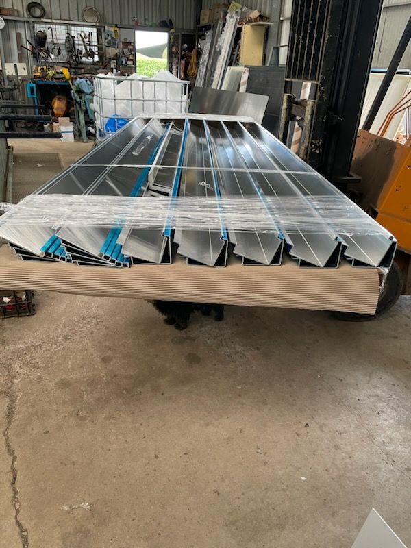 A large piece of metal is sitting on top of a wooden table  | Berkshire Park, NSW | V.J.S. Aluminium & Steel