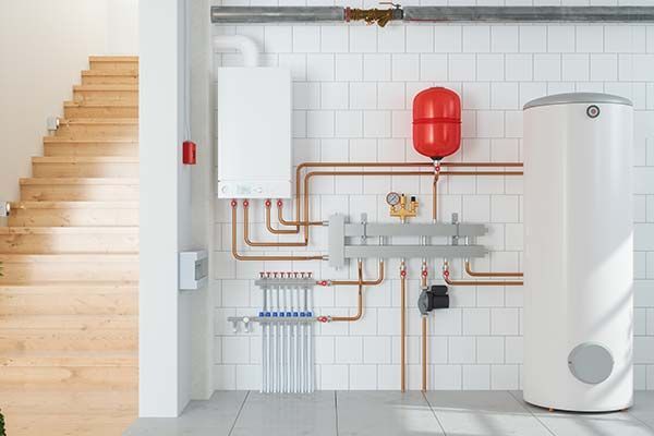 There is a boiler and a water heater in the room.