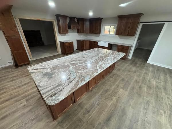 There is a large island in the middle of the kitchen.