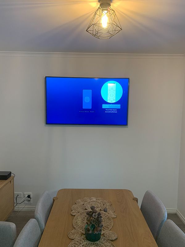 Room With A Table And Chairs And A Tv On The Wall — Telecommunication Company In Murrumbateman, ACT