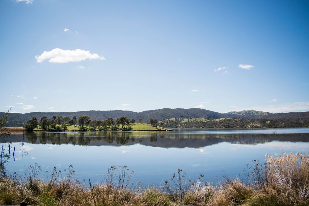 Large Body Of Water With Mountains In The Background — Telecommunication Company In Googong, ACT