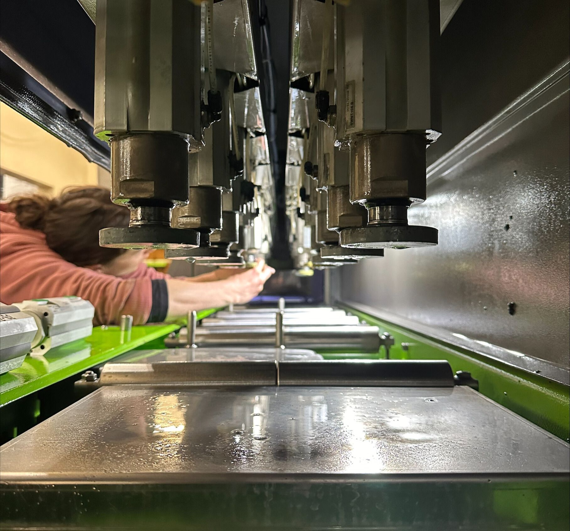 A person is working on a machine that is very long