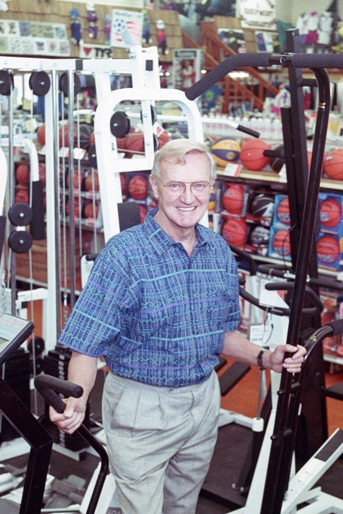 A man is riding an exercise bike in a gym