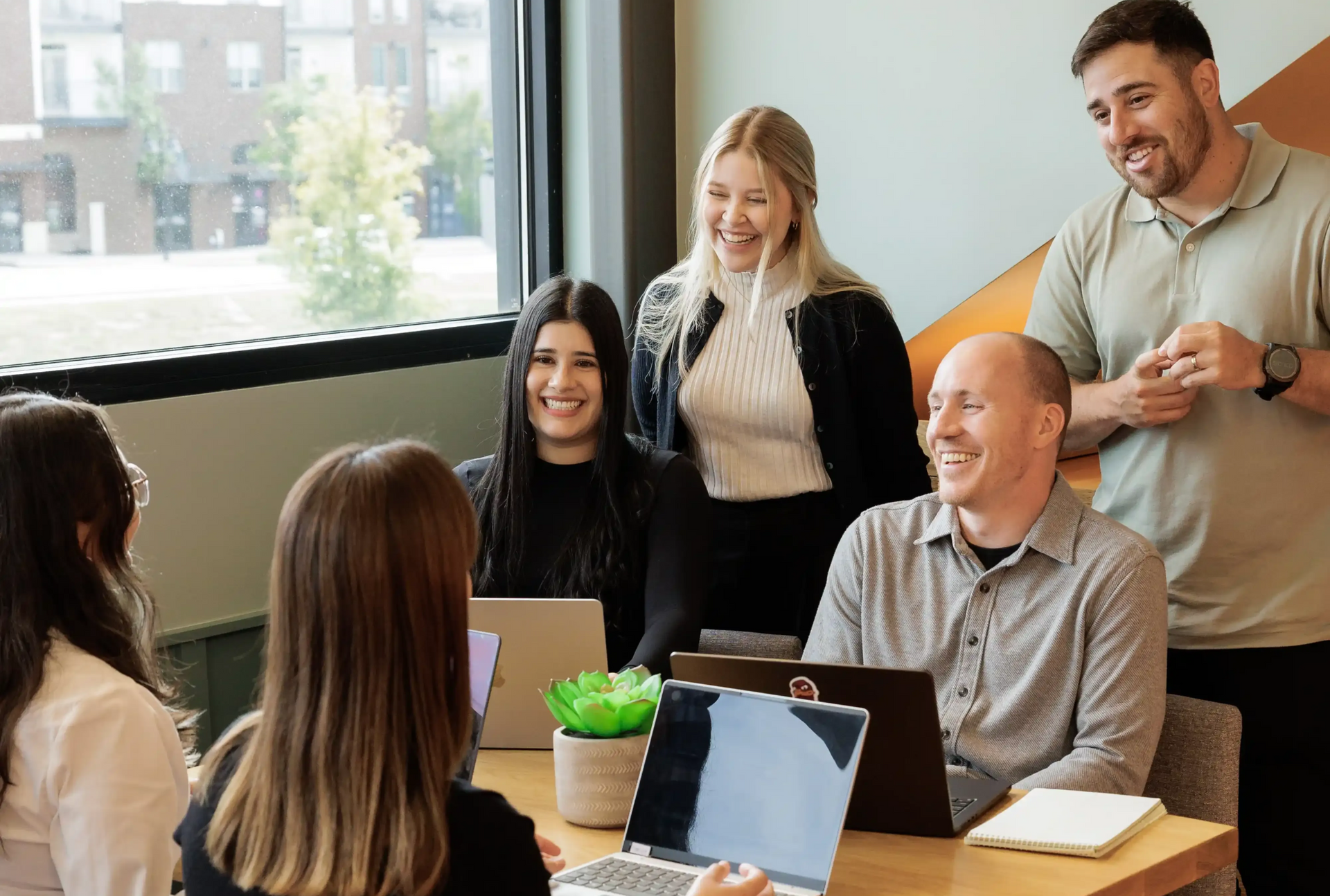 Career Coach Adam Broda Smiling With Broda Coaching Team Discussing Strategies for Finding Networking Events for Senior Level Professionals