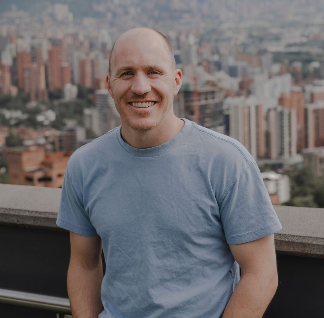 Career Coach Adam Broda Smiling on Rooftop Overlooking City Ready to Share Interview Question Guidance