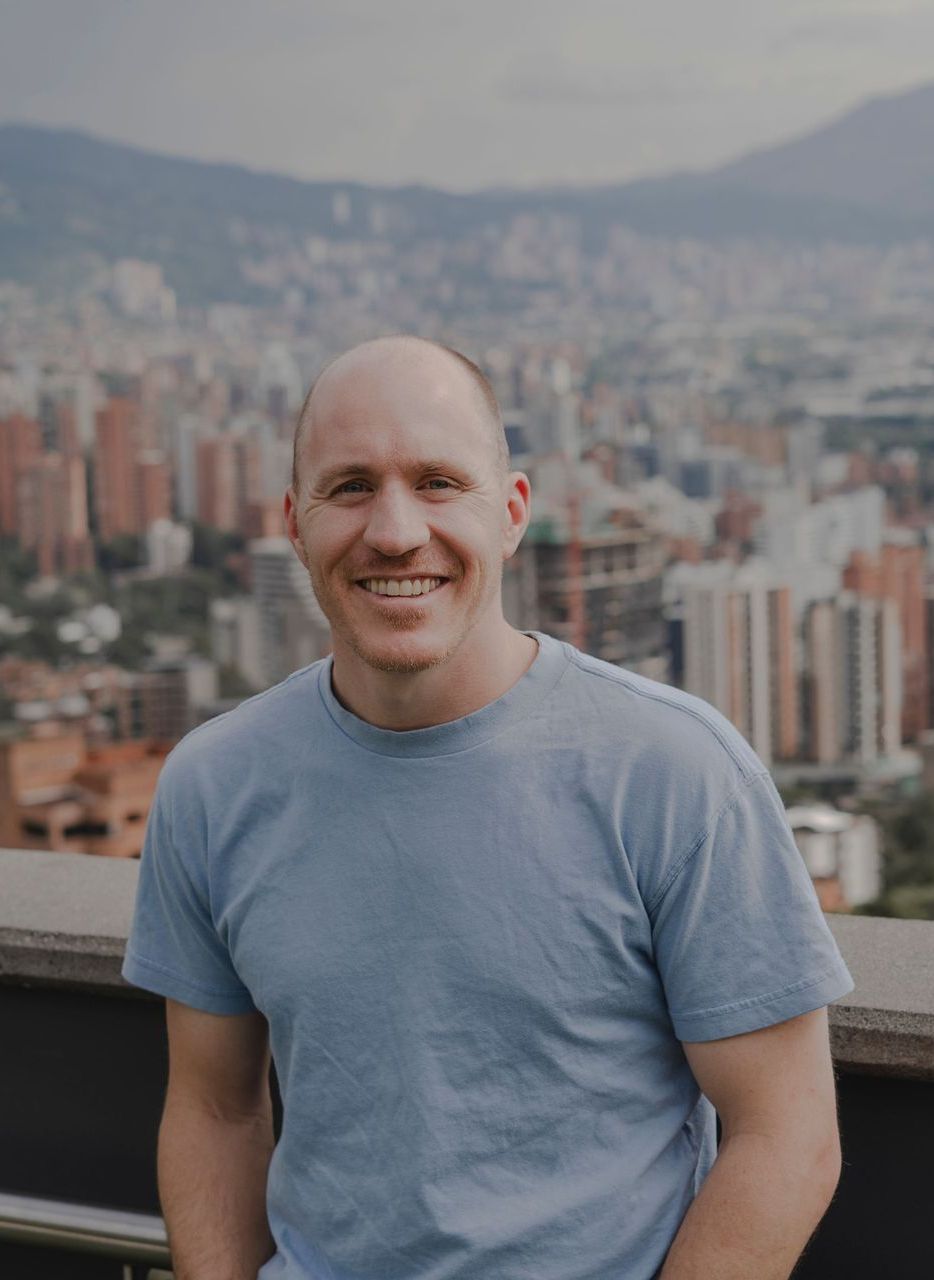Coach Adam Broda Smiling on Rooftop Overlooking City