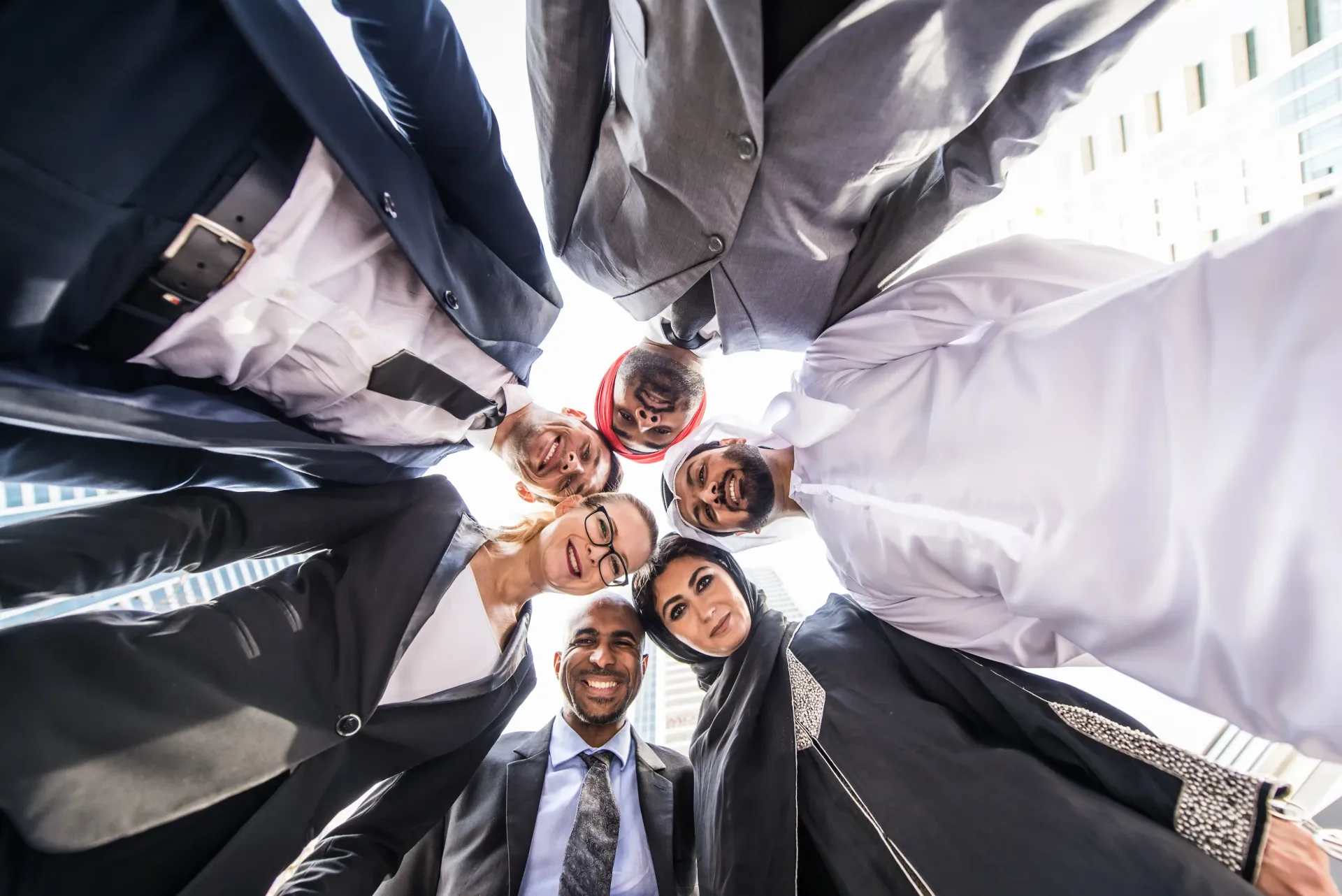 A group of people are standing in a circle looking down at the camera as each of them has their own unique personal brand.