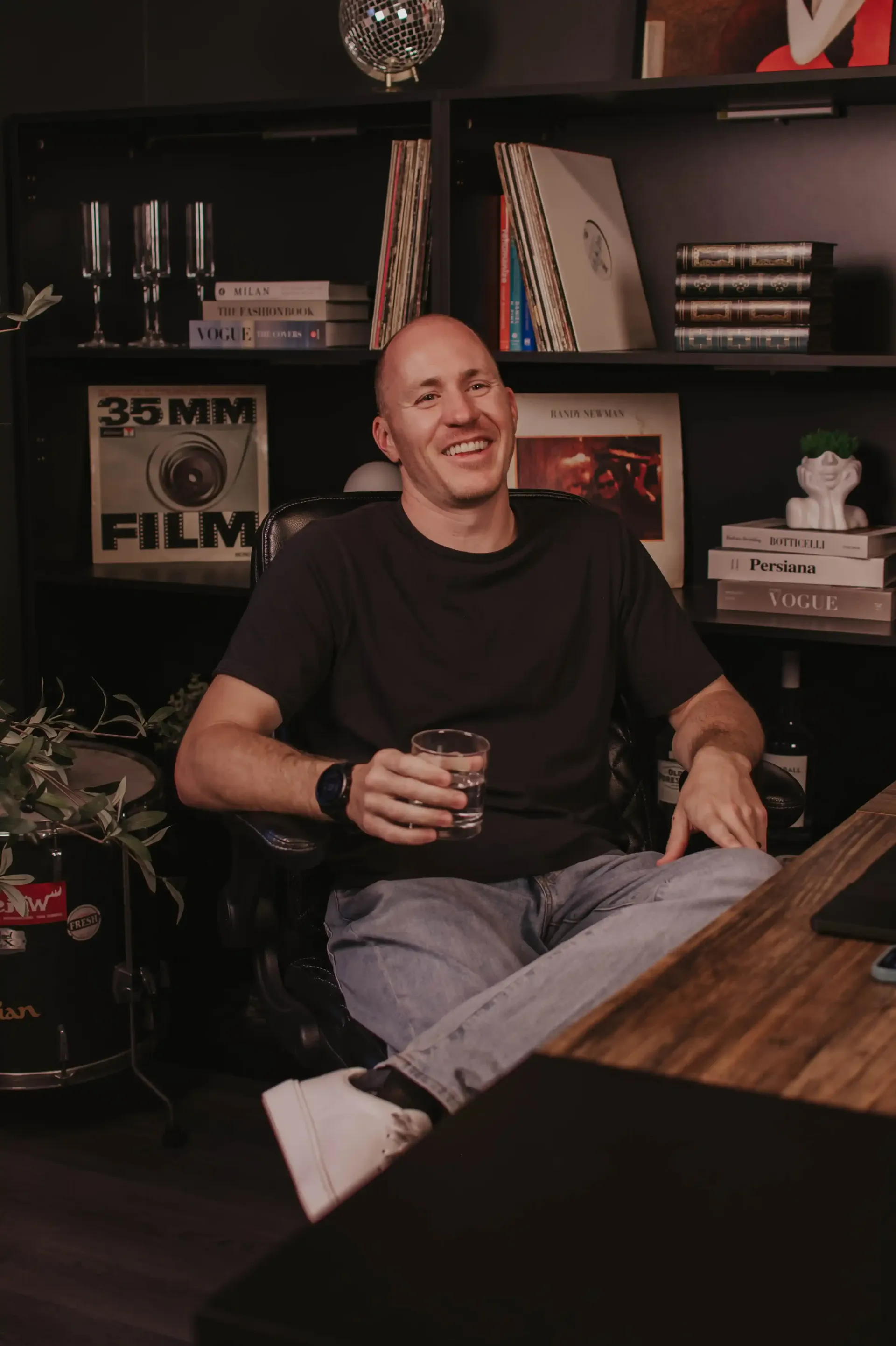 Coach Adam Broda Smiling At Desk In Office