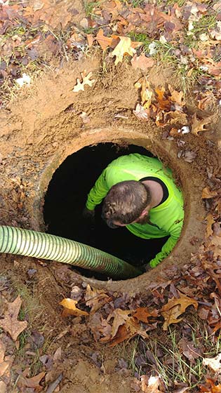 Septic Contractor Wrightstown — Worker Inside Manhole in North Hanover, NJ