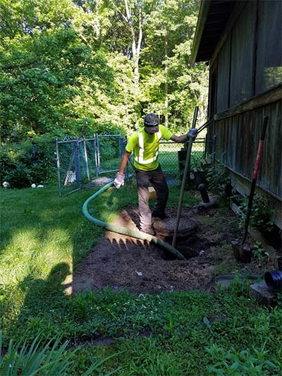 Septic Contractor — Worker Cleaning Septic Tank in Wrightstown, NJ
