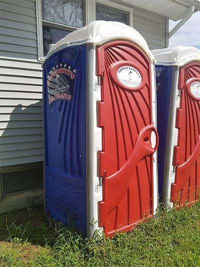 Septic Tanks — Red and Blue New Portable Toilet in North Hanover, NJ