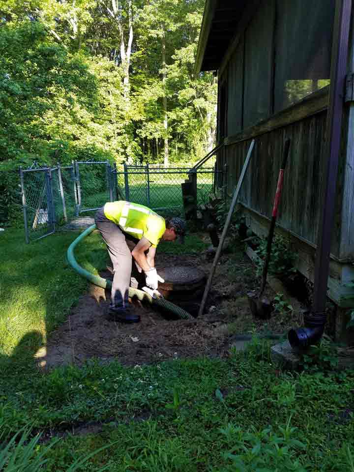 Septic Contractor — Worker Setting Up Vacuum on Septic Tank in North Hanover, NJ