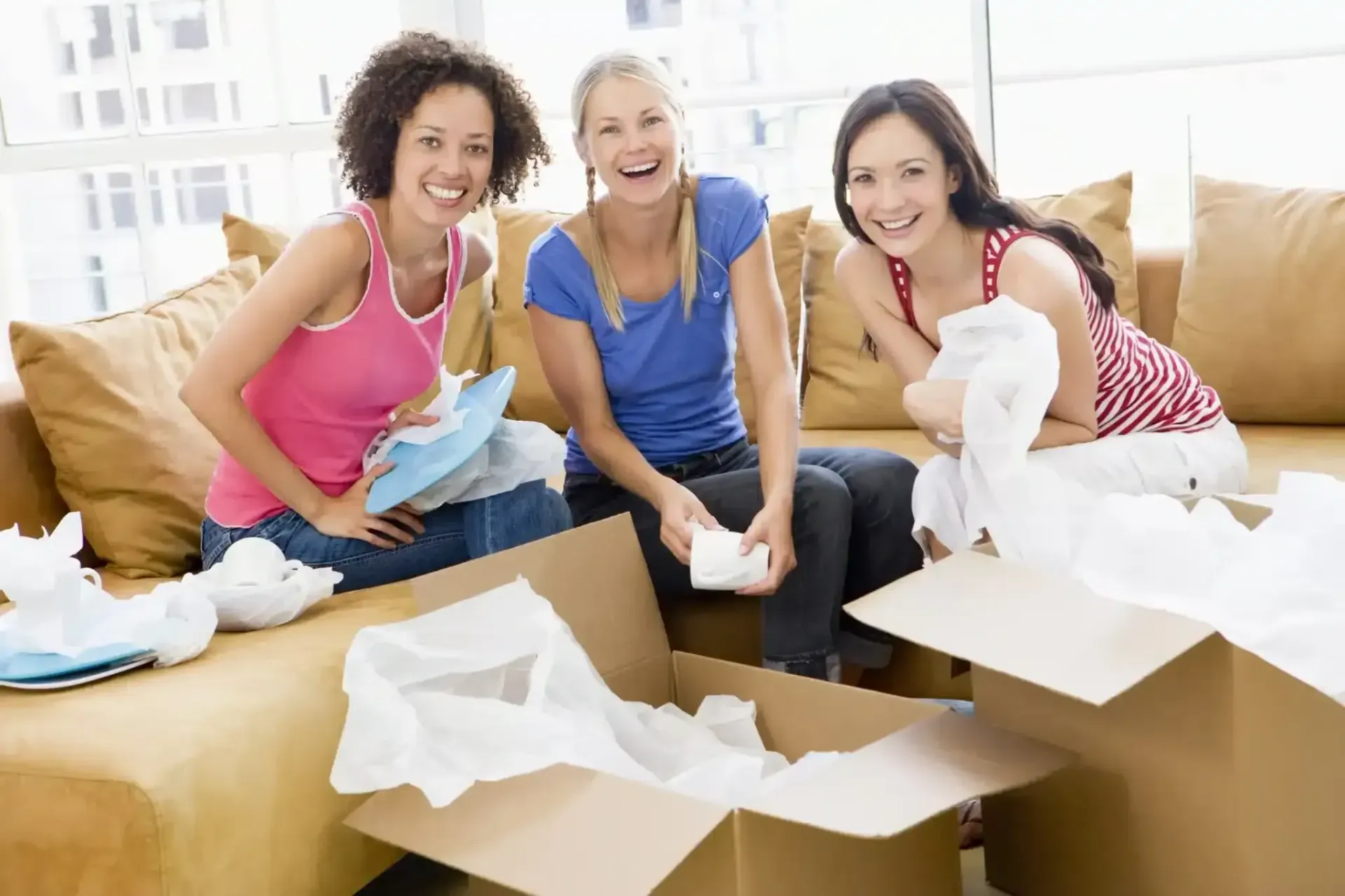Three Women Are Sitting on a Couch — Easy Choice Removals and General Freight In Port Macquarie, NSW