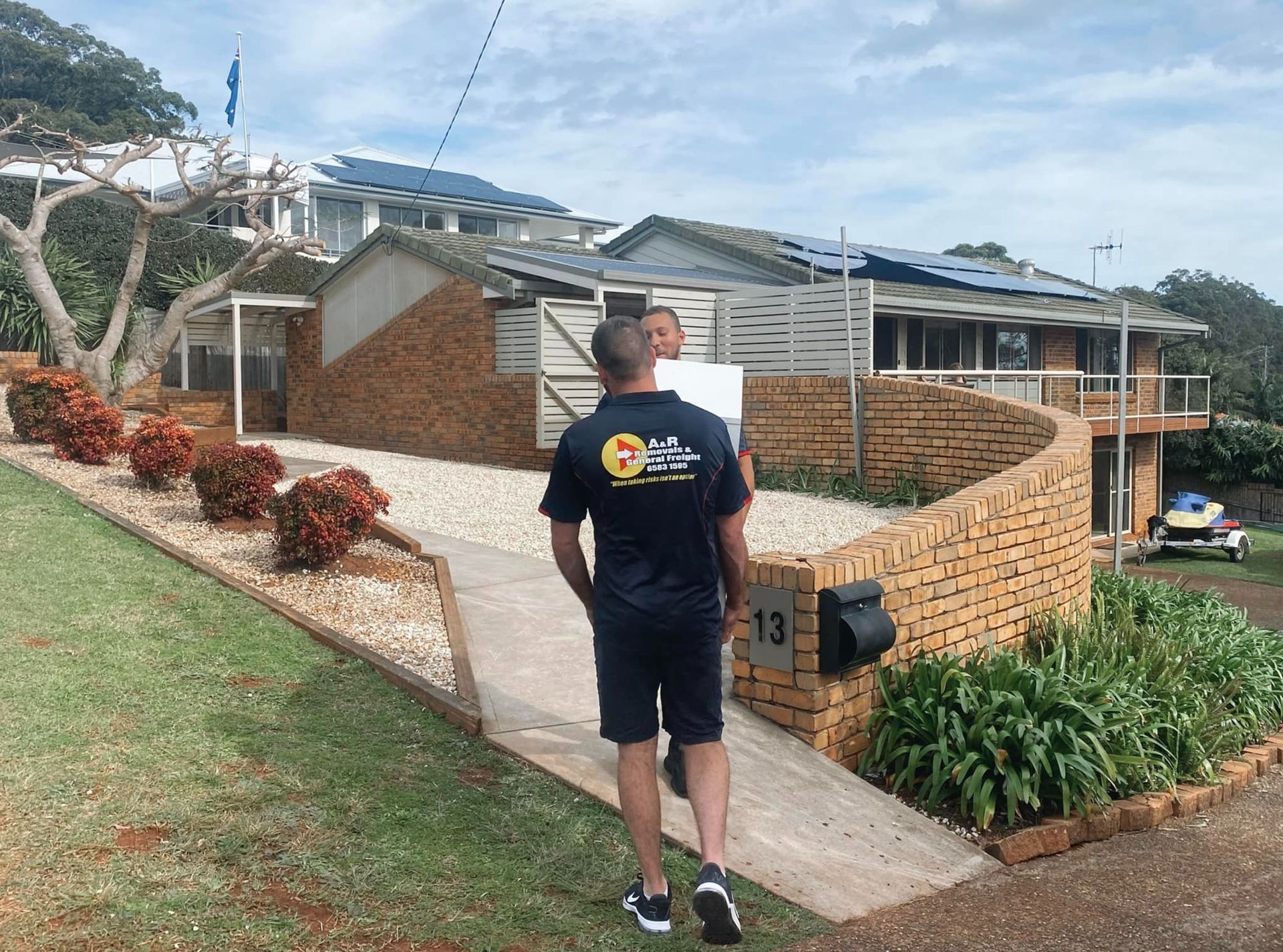A Man is Walking Down a Sidewalk — Easy Choice Removals and General Freight In Port Macquarie, NSW