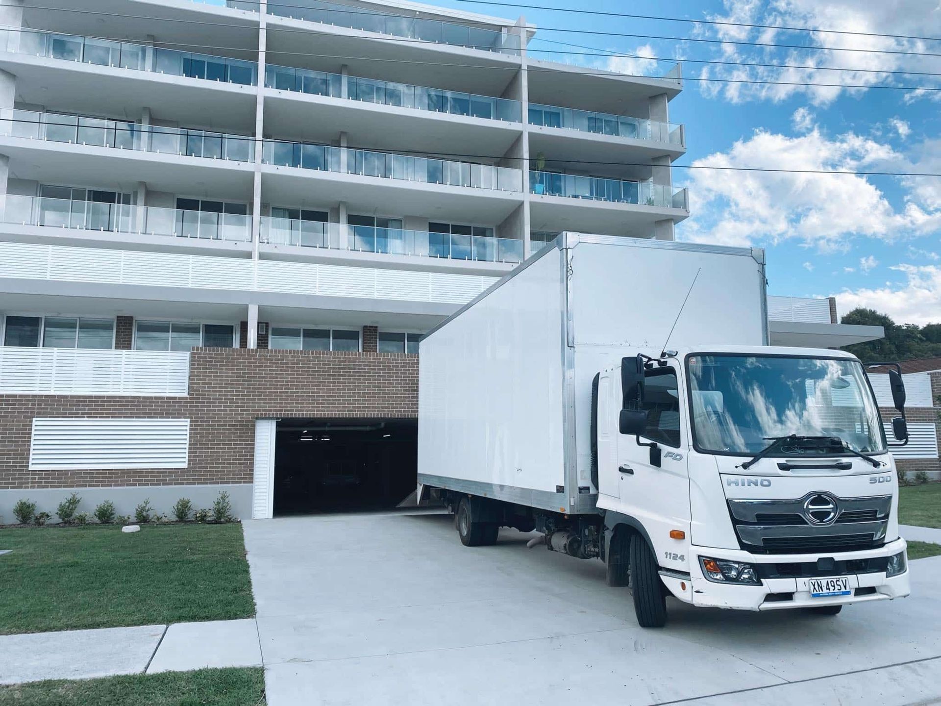 A White Truck is Parked in Front of a Building — Easy Choice Removals and General Freight In Port Macquarie, NSW