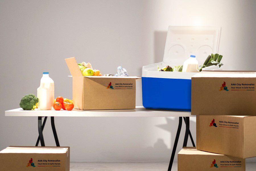 A Table With Boxes of Food and a Cooler on It — Easy Choice Removals and General Freight In Port Macquarie, NSW