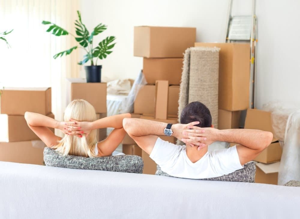A Man and a Woman Are Sitting on a Couch — Easy Choice Removals and General Freight In Port Macquarie, NSW