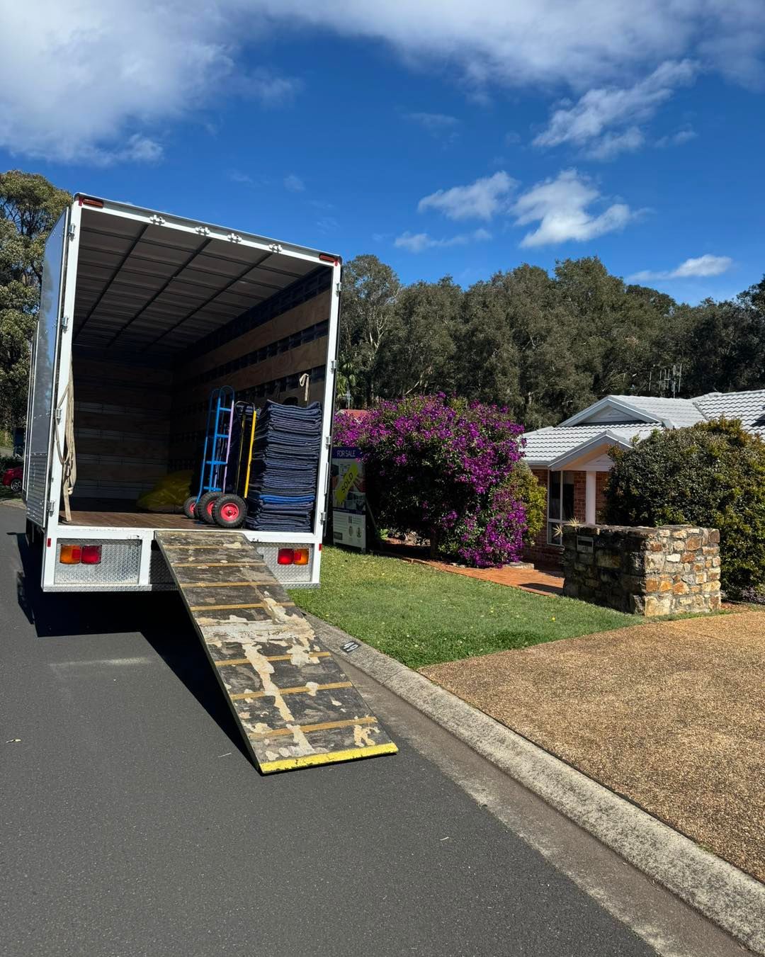 Moving Truck Parked On A Street With Ramp Down.