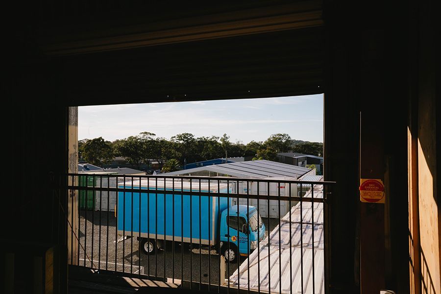A Blue Truck Parked Outside of a Loading Bay — Easy Choice Removals and General Freight In Port Macquarie, NSW