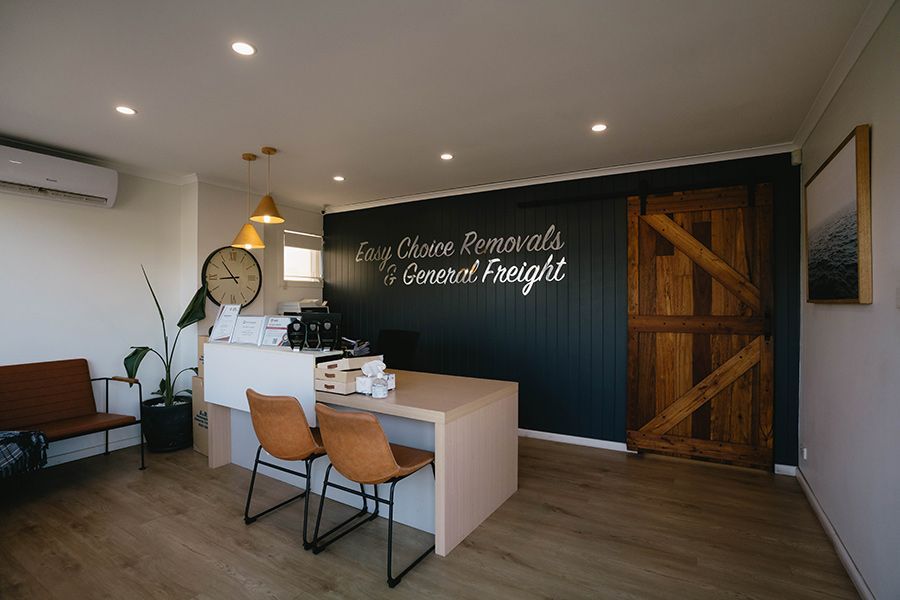 Reception Area With Desk, Chairs, and a Dark Blue Wall — Easy Choice Removals and General Freight In Maitland, NSW