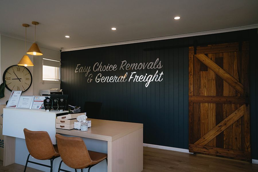 A Living Room Filled With Boxes and a Couch — Easy Choice Removals and General Freight In Coffs Harbour, NSW