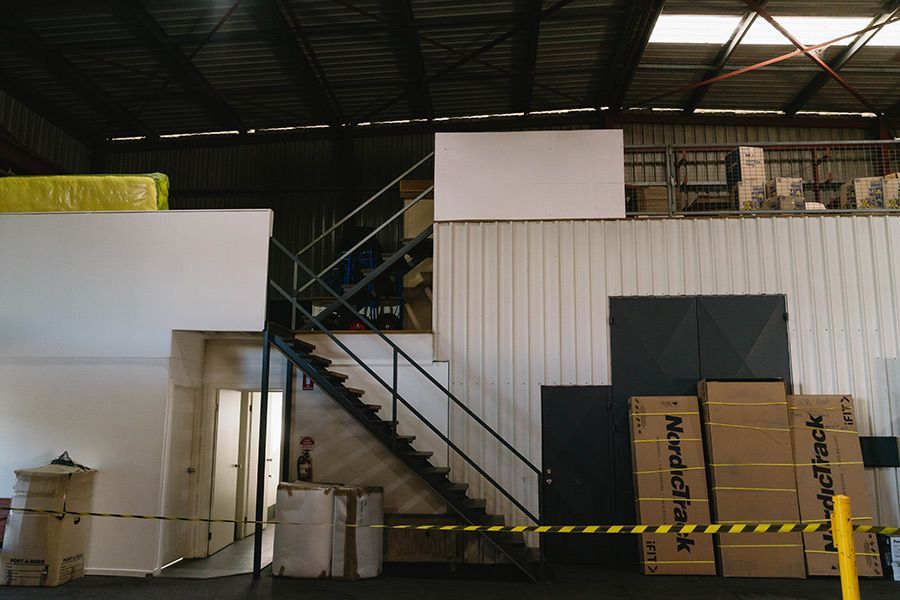 Warehouse Interior With Metal Staircase — Easy Choice Removals and General Freight In Port Macquarie, NSW
